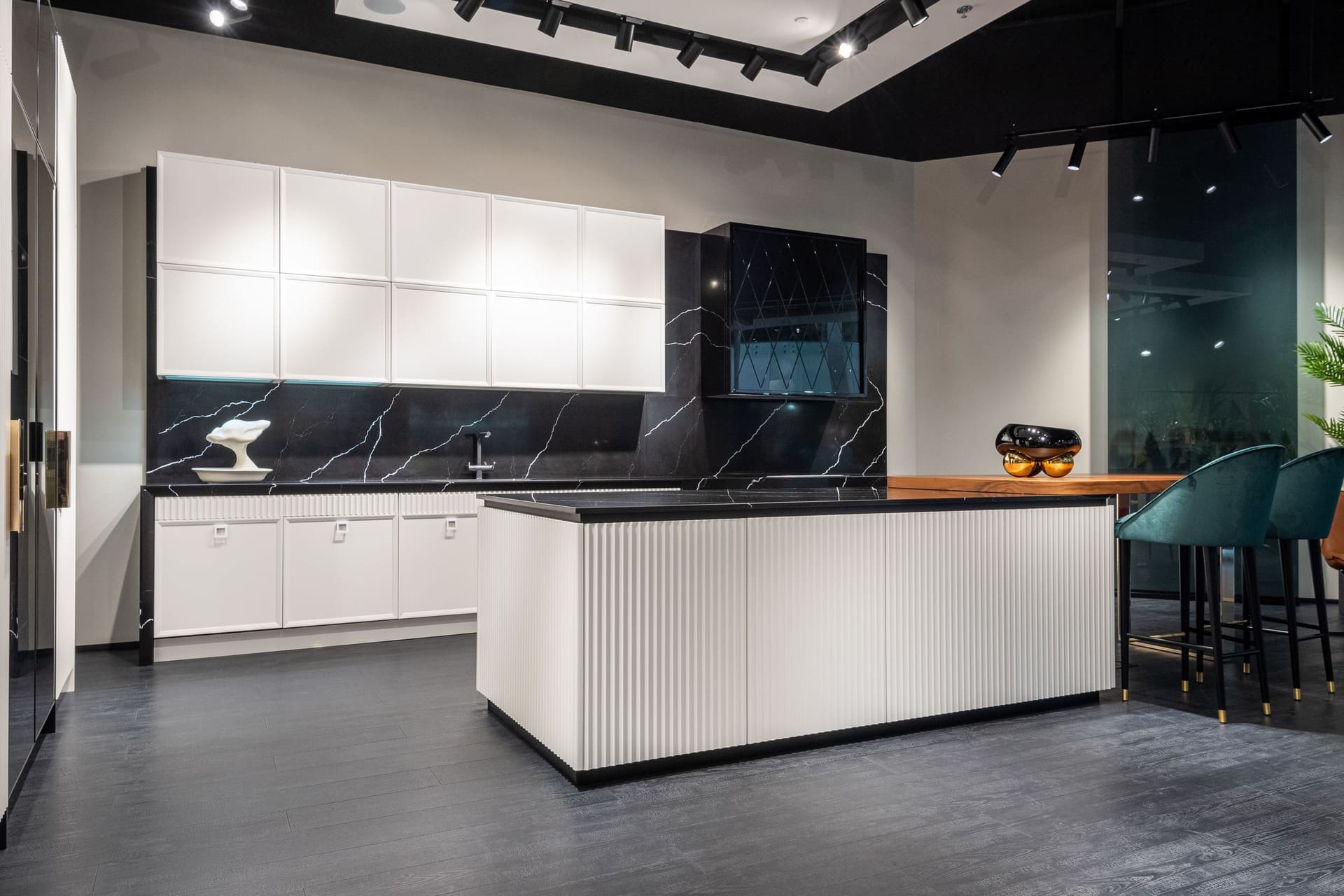The finished kitchen with a full-length island and integrated appliances