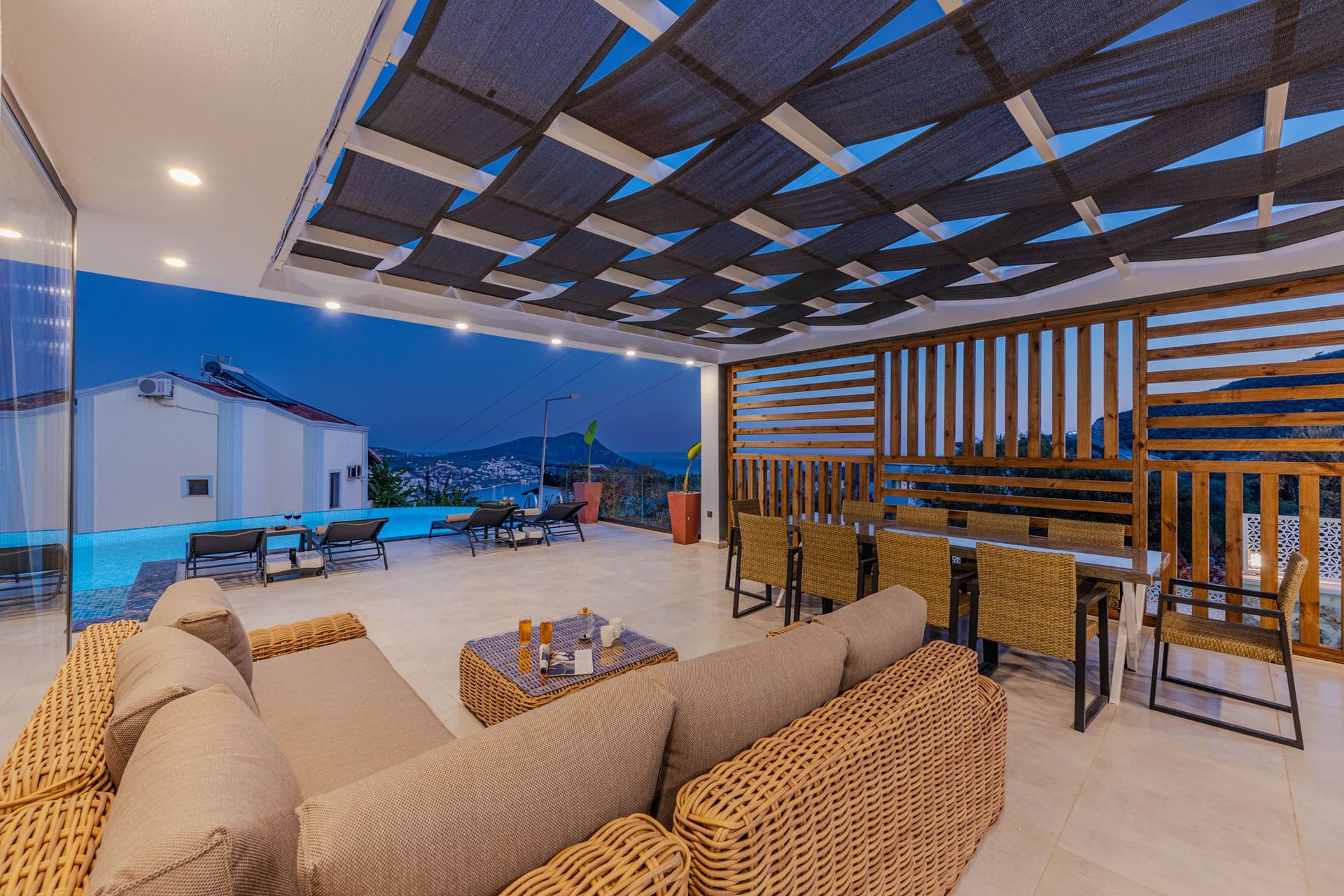 A covered outdoor terrace with a dining table