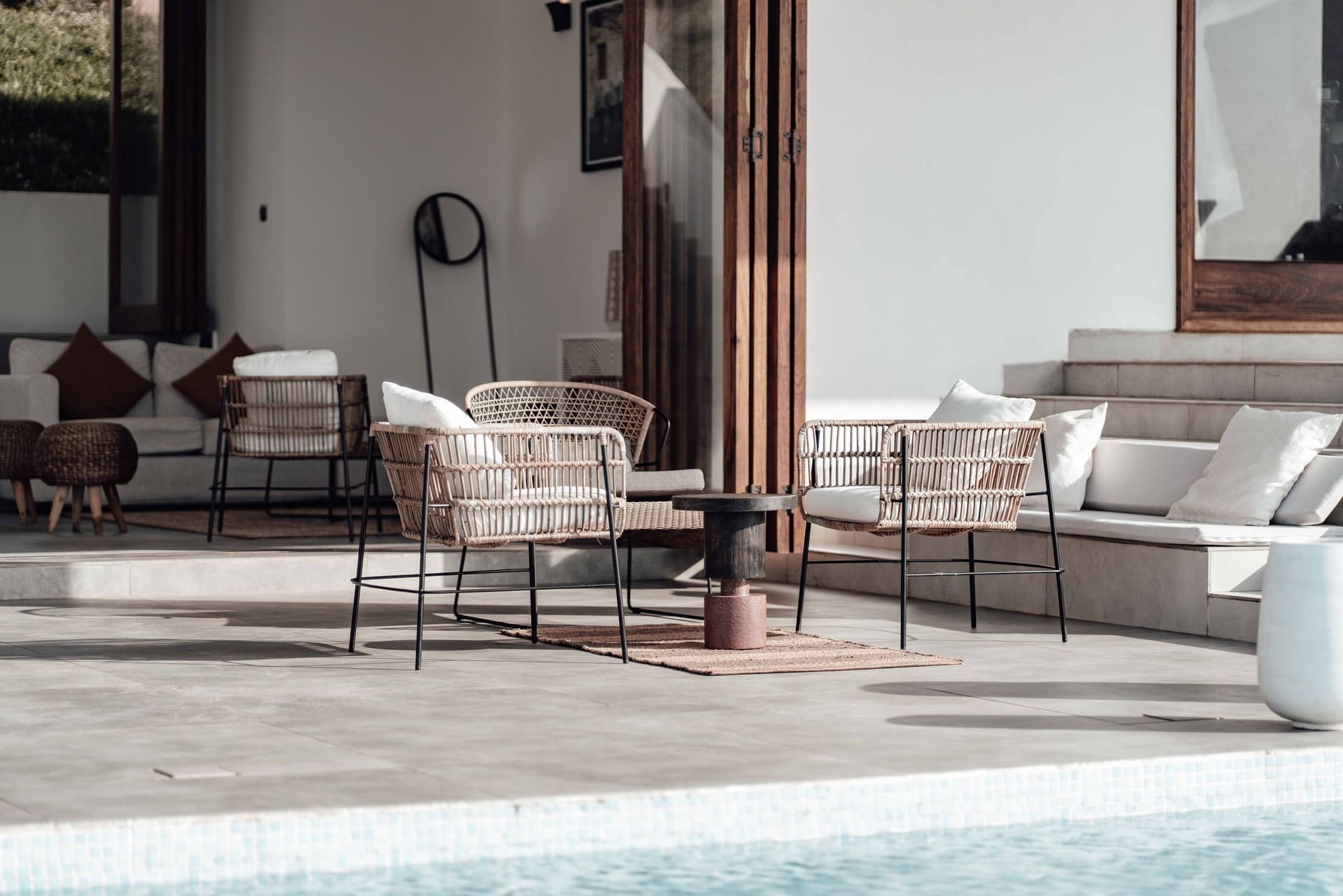 The finished covered terrace with seating beside the pool